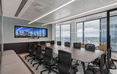 an empty conference room with a large flat screen tv on the wall