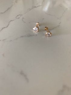 "14K Bezel Heart Earrings, Dainty Earrings, Women Earrings, Kid Earrings, Solid Gold Heart Bezel Earrings, Gold Hearts, Gold Heart Earrings ♦ Materials: 14kt Solid Gold, Stone: Cubic Zirconia ♦ Available colors: Clear Cubic Zirconia on Yellow Gold ♦ Closure: Screw Backs ♦ Earrings Measurements:5x5 (WxH) Millimeters in diameter -------------------------------------------------- ♦ -------------------------------------------------- PRODUCTION TIMES Order processing time varies between 1-2 business Heart Cut Earrings With Heart Beads For Anniversary, Fine Jewelry Heart Earrings For Pierced Ears, 14k Gold Heart Earrings With Heart Cut, Dainty Heart Cut Earrings With Heart Charm, Pierced Heart Cut 14k Gold Heart Earrings, 14k Gold Heart Cut Pierced Earrings, 14k Gold Heart Cut Pierced Heart Earrings, 14k Gold Dainty Heart Cut Earrings, 14k Gold Heart Earrings With Heart Charm