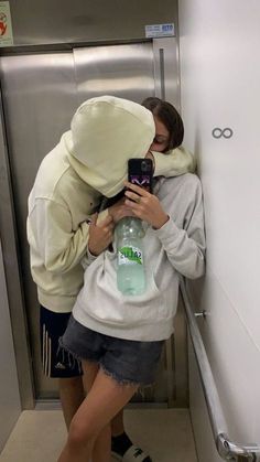 two people hugging each other in an elevator