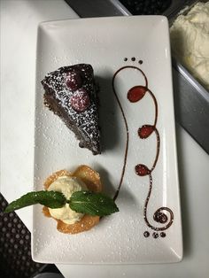 three desserts on a white plate sitting on a table