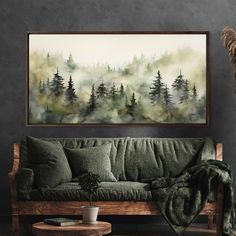 a living room with a couch, coffee table and painting on the wall above it