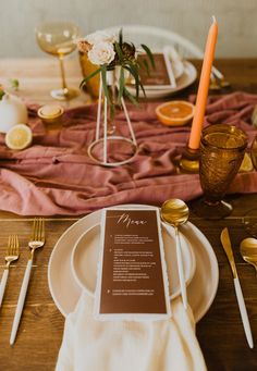 a table setting with place settings, napkins and utensils