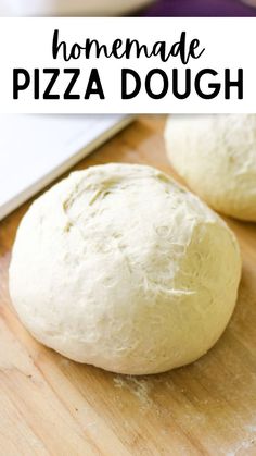 two uncooked doughnuts sitting on top of a wooden cutting board