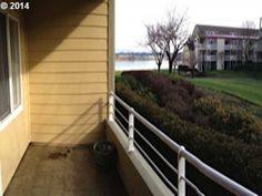 a balcony with a view of the water and houses