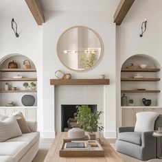 a living room filled with furniture and a fire place in front of a white fireplace