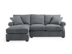 a gray couch with pillows on it and a footstool next to it, against a white background