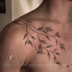 a man's chest with leaves on it and the word faco tatoo