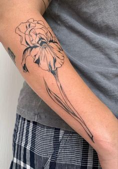 a man's arm with a flower tattoo on the left side of his arm