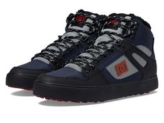 a pair of black and grey sneakers with red accents on the upper part of the shoe