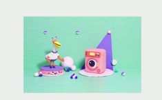 a toy camera sitting on top of a cake next to a fake bird and other items