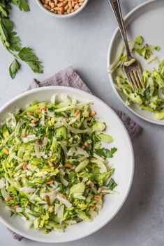 a white bowl filled with shredded broccoli and nuts next to another bowl full of chopped broccoli