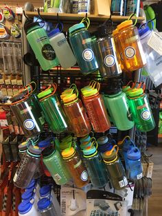 there are many water bottles on display in the store