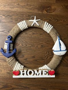 a wreath made out of rope with an anchor, boat and starfish on it