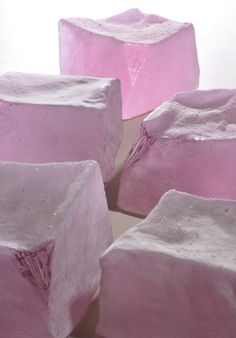 several pieces of pink soap sitting on top of each other