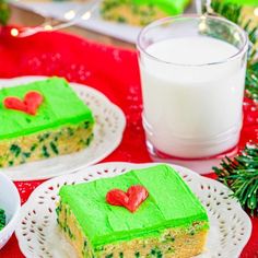 there are two pieces of cake on the plates next to a glass of milk and some broccoli