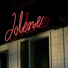 a red neon sign that reads dobbos on the side of a building