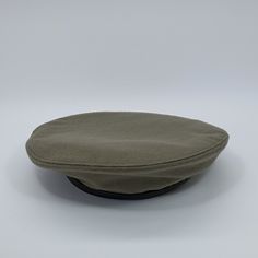 Only size:55cm. Please note that there is a minor imperfection in the material, represented by a red thread on the left side. This flaw is visible in the photographs. A historical military reproduction of the beret worn by The 1st Independent Polish Parachute Brigade, which was led by General Stanisław Sosabowski, is available. The beret's color is predominantly gray with a hint of khaki. Its crown is crafted from soft wool fabric, featuring a quilted cotton lining and a sweatband made of genuin Adjustable Brown Brimmed Beret, Military Style Green Flat Cap, Army Beret, Green Military Flat Cap, Brown Military Hat With Curved Brim, Military Beret, Wool Fabric, Sewing Techniques, Green And Grey