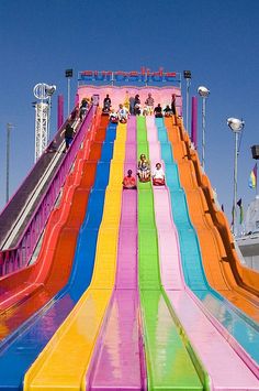 a colorful water slide with people on it