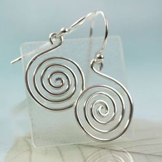 "Simple and timeless. A sterling silver hand forged spiral with large jump ring ready to hang on your favourite chain. The spiral symbol can represent the path leading from outer consciousness (materialism, external awareness, ego, outward perception) to the inner soul (enlightenment, unseen essence, nirvana, cosmic awareness). The symbol has been a favourite of many ancient tribes and people. The thickness of the wire is 1.5 mm and the diameter horizontally is about 20 mm. The length including Modern Spiral Sterling Silver Jewelry, Modern Sterling Silver Spiral Jewelry, Minimalist Spiral Hand Forged Jewelry, Symbolic Spiral Sterling Silver Jewelry, Spiral Hand Forged Sterling Silver Jewelry, Spiral Shaped Sterling Silver Jewelry, Sterling Silver Swirl Jewelry, Sterling Silver Swirl Jewelry In Silver, Hypoallergenic Spiral Sterling Silver Jewelry