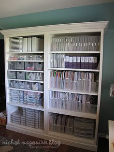 a white bookcase filled with lots of books