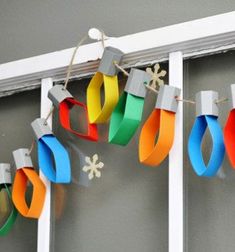 colorful paper wreaths are hanging on the window sill