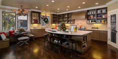 a large kitchen with an island in the middle and lots of cabinets on both sides