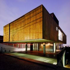 a large wooden building sitting on the side of a road