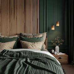 a bedroom with green walls and wooden headboard