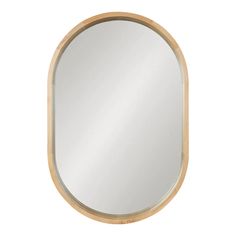 an oval wooden mirror on a white wall with a light wood trim around the edge