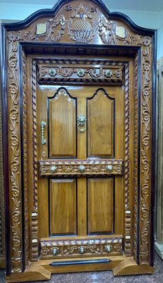 an ornate wooden door with carvings on it