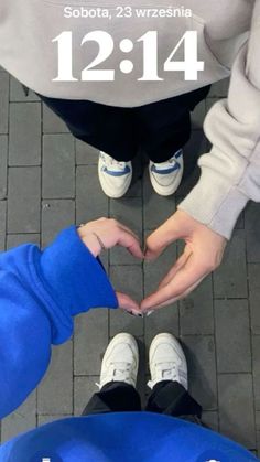 two people making a heart shape with their hands and feet in front of the camera