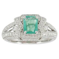 This spectacular ring from the Suzy Levian Limited Edition collection features a Colombian emerald gemstone held in a square shaped 14K white gold prong setting. An array of 114 side white diamonds (.93ct tdw) with hand-carved French filigree work across the band, accents the perfect white gold color of the square cut center stone emerald (1.07ct) The brilliance of these gems and the luster of the high-polish finish of the white gold creates an eye catching piece of jewelry. Jewelry Type: Fine S Emerald Band, White Diamond Ring, Contemporary Ring, Colombian Emeralds, Emerald Gemstone, White Metal, Cocktail Rings, White Diamond, Diamond White