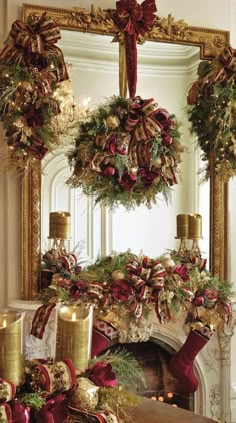 a fireplace decorated for christmas with wreaths and candles