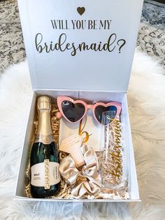 a white box filled with champagne, glasses and confetti on top of a furnishing