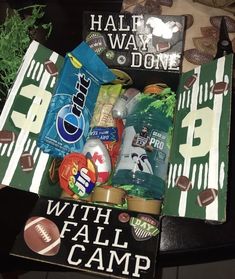 a football themed box filled with snacks and candy for the gameday party or tailgating