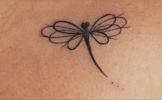 a tattoo on the back of a woman's neck with a dragonfly design