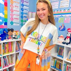 a girl standing in front of a book shelf