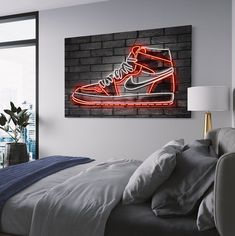 a bedroom with a brick wall and a neon nike shoe on the wall above the bed