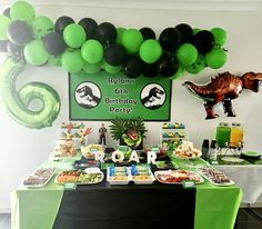 a dinosaur themed birthday party with balloons and food