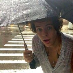 a woman holding an umbrella in the rain