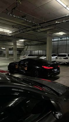 several cars are parked in an empty parking garage