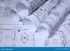 rolls of architectural paper on top of blueprint drawings stock photo image 519784