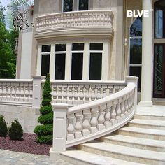 a large white house with stairs leading up to the front door and side entrance area