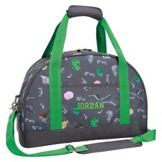 a duffel bag with an image of the gameboy pattern and green straps on it