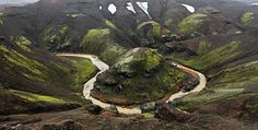 an aerial view of a river running through the mountains