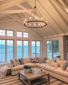 a living room filled with furniture and large windows