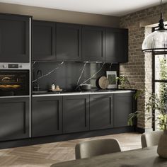 a modern kitchen with black cabinets and marble counter tops, an oven in the center