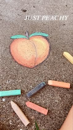 chalk crayons are arranged in the shape of an apple with words just peachy written on it