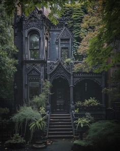 an old house with stairs leading up to it