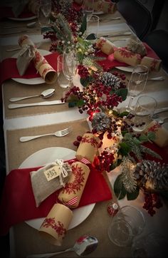 the table is set with place settings for christmas dinner